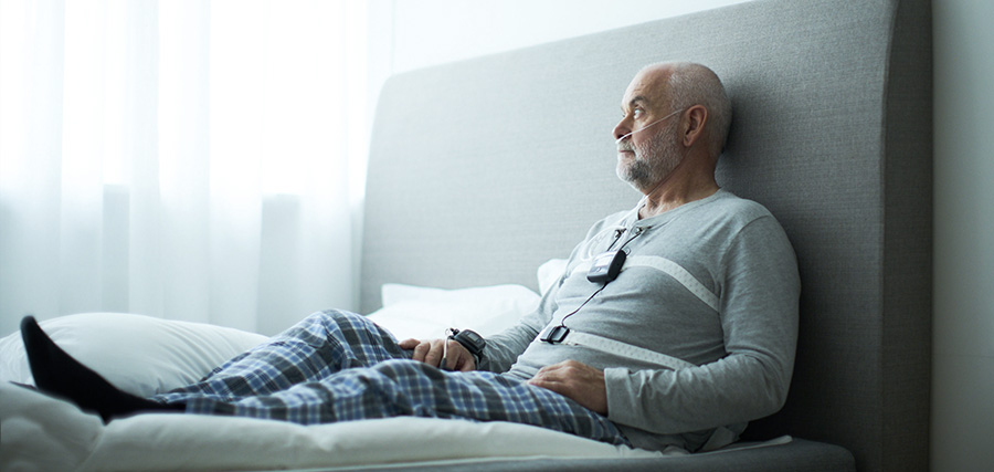 Patient relaxing in bed wearing a home sleep study device